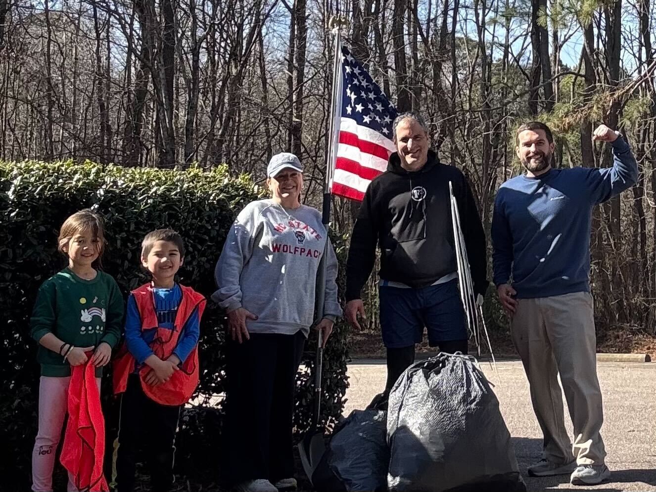 F3 men and families with bags of collected litter