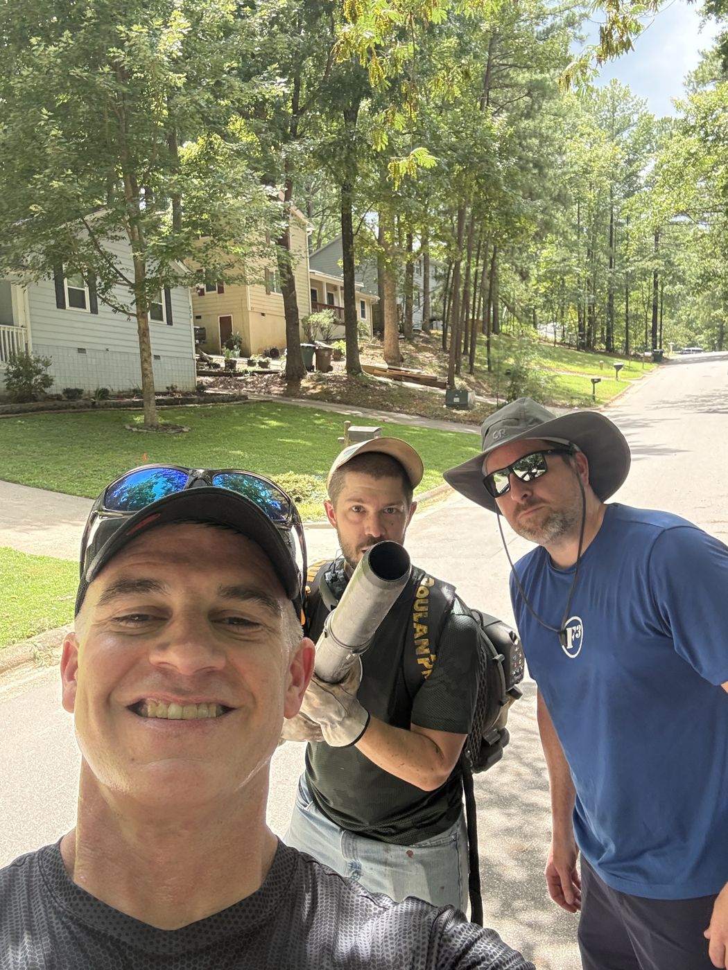 Three F3 men with a leaf blower after yard work